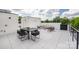 A roof deck with a dining table and cushioned seating with a distant city skyline at 614 Queens Rd, Charlotte, NC 28207