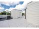 Modern rooftop deck featuring gray tile, an AC unit, and exterior walls at 614 Queens Rd, Charlotte, NC 28207