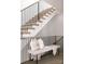 Contemporary staircase with black railings and a cozy bench adorned with decorative pillows and a throw at 614 Queens Rd, Charlotte, NC 28207