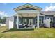 Charming backyard featuring a covered patio with seating and a well-manicured lawn at 6295 Ashton Park Dr, Denver, NC 28037