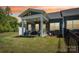 Inviting backyard with covered patio, outdoor seating, and lush lawn, perfect for relaxation and entertaining at 6295 Ashton Park Dr, Denver, NC 28037