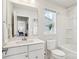 Well-lit bathroom with a large mirror, bright white cabinets, and a shower-tub combination at 6295 Ashton Park Dr, Denver, NC 28037