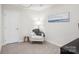 Cozy bedroom area with chair, side table, and serene artwork, creating a peaceful retreat at 6295 Ashton Park Dr, Denver, NC 28037