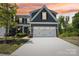 Charming two-story home boasts a well-lit garage and meticulous landscaping for a welcoming curb appeal at 6295 Ashton Park Dr, Denver, NC 28037