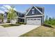 Charming home with a two-car garage, manicured lawn and beautiful landscaping at 6295 Ashton Park Dr, Denver, NC 28037