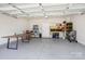 Spacious garage with epoxy floors and ample storage, featuring a TV and ping pong setup at 6295 Ashton Park Dr, Denver, NC 28037