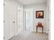 Bright hallway featuring neutral walls, plush carpet, and decorative accents on a wooden table at 6295 Ashton Park Dr, Denver, NC 28037
