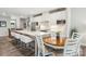 Bright, modern kitchen features white cabinets, stainless steel appliances, and a center island with bar seating at 6295 Ashton Park Dr, Denver, NC 28037