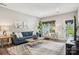 Living room with neutral walls and decor, a comfortable sofa, and large windows at 6295 Ashton Park Dr, Denver, NC 28037