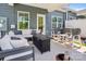 Stylish covered patio with comfortable seating, a fire pit, and ample space for relaxation at 6295 Ashton Park Dr, Denver, NC 28037