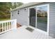 A white wood back deck with gray wood flooring is entered by a sliding glass door at 6300 Bill Sain Rd, Vale, NC 28168