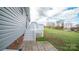 Rear exterior featuring a cozy patio area, grassy yard and convenient access to backyard space at 6300 Bill Sain Rd, Vale, NC 28168