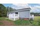 View of the gray vinyl sided home with a well-maintained backyard and white wood deck at 6300 Bill Sain Rd, Vale, NC 28168
