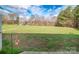 A picturesque backyard view with a hanging basket in a well maintained yard at 6300 Bill Sain Rd, Vale, NC 28168