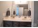 Stylish bathroom with a double vanity and great lighting, featuring a view of the shower and toilet at 6300 Bill Sain Rd, Vale, NC 28168