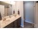 Bathroom featuring double sinks, a large mirror, dark wood cabinetry, and modern fixtures at 6300 Bill Sain Rd, Vale, NC 28168