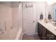 Bright bathroom featuring a shower with a tub, a modern vanity, and excellent natural light at 6300 Bill Sain Rd, Vale, NC 28168