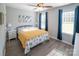 Charming bedroom with ample natural light, wood-look flooring, and stylish blue curtains at 6300 Bill Sain Rd, Vale, NC 28168