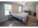 Bright bedroom featuring wood floors, natural light, ceiling fan, and a calming neutral color palette at 6300 Bill Sain Rd, Vale, NC 28168