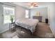 Inviting bedroom with wood-look flooring, abundant natural light, and a ceiling fan for added comfort at 6300 Bill Sain Rd, Vale, NC 28168
