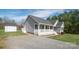 View of house featuring covered front porch with gray siding and a shed with a spacious yard at 6300 Bill Sain Rd, Vale, NC 28168