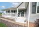 Inviting front porch featuring ample seating space, decorative elements, and classic curb appeal at 6300 Bill Sain Rd, Vale, NC 28168