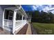 Inviting front porch featuring ample seating space, decorative elements, and landscape at 6300 Bill Sain Rd, Vale, NC 28168