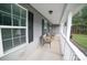 Inviting covered front porch showcasing cozy seating with a view of the front yard at 6300 Bill Sain Rd, Vale, NC 28168
