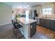 The kitchen features stainless steel appliances, gray cabinets, and island with seating at 6300 Bill Sain Rd, Vale, NC 28168