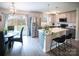 Modern kitchen with stainless steel appliances, island with seating and an adjacent dining area at 6300 Bill Sain Rd, Vale, NC 28168
