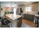 The kitchen features stainless steel appliances, gray cabinets, and island with seating at 6300 Bill Sain Rd, Vale, NC 28168