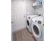 Bright laundry room with modern washer and dryer, and practical shelving for storage solutions at 6300 Bill Sain Rd, Vale, NC 28168