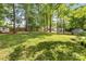 Large backyard with mature trees, a shed, and a spacious lawn perfect for outdoor enjoyment at 709 Weldon Ln, Salisbury, NC 28146