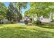 Expansive backyard featuring a pool, deck, mature trees, and lush green lawn at 709 Weldon Ln, Salisbury, NC 28146