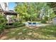 Backyard pool featuring a gazebo, lounge chairs, well-maintained lawn, and lush green landscaping at 709 Weldon Ln, Salisbury, NC 28146