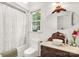 Elegant bathroom featuring a vintage vanity with marble countertop, and a shower-tub combo at 709 Weldon Ln, Salisbury, NC 28146