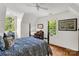 Sunlit bedroom with hardwood floors, complemented by a four-poster bed and vintage-style furnishings at 709 Weldon Ln, Salisbury, NC 28146