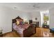 Bright bedroom featuring a wooden bed frame, colorful bedding, and hardwood floors at 709 Weldon Ln, Salisbury, NC 28146