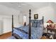 Cozy bedroom featuring a four-poster bed, hardwood floors, and white walls at 709 Weldon Ln, Salisbury, NC 28146