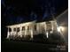 Well-lit home at night with a cozy front porch and manicured landscaping at 709 Weldon Ln, Salisbury, NC 28146