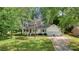 Charming home with a manicured lawn, mature trees, and an attached two-car garage at 709 Weldon Ln, Salisbury, NC 28146