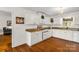 Well-lit kitchen featuring white cabinets, granite countertops, and hardwood floors at 709 Weldon Ln, Salisbury, NC 28146