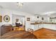 Bright kitchen featuring white cabinets, granite countertops, and hardwood floors open to the breakfast nook at 709 Weldon Ln, Salisbury, NC 28146