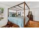 Light-filled main bedroom featuring a four-poster bed and hardwood floors at 709 Weldon Ln, Salisbury, NC 28146