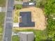A top-down view of the house showing dark shingles and a street with cars at 722 English St, Monroe, NC 28110