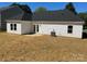 View of the home's backyard, featuring a cozy patio and ample green space at 722 English St, Monroe, NC 28110
