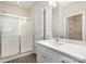 Modern bathroom with glass-enclosed shower, white cabinets, and large mirror, providing a sleek feel at 722 English St, Monroe, NC 28110