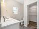 Bright bathroom with dual sinks, plenty of vanity countertop space, and access to the closet at 722 English St, Monroe, NC 28110