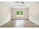 An airy bedroom features sleek floors, two windows, and a trey ceiling, offering a blank canvas at 722 English St, Monroe, NC 28110