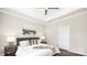 Bright bedroom featuring a tray ceiling, ceiling fan, and stylish decor for a modern aesthetic at 722 English St, Monroe, NC 28110